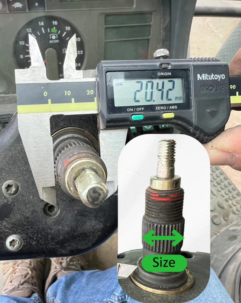 Measuring the steering shaft diameter with a caliper to choose the right adapter size